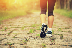 50530016 - young fitness woman legs walking on forest trail