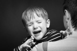 57238319 - portrait of a crying son on hands a father