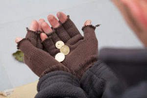 23049399 - homeless person holding a few cents in his hands