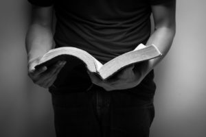 41906884 - a man reading the holy bible.