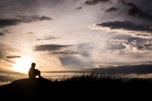 57330243 - sad boy silhouette worried on the meadow at sunset ,silhouette concept